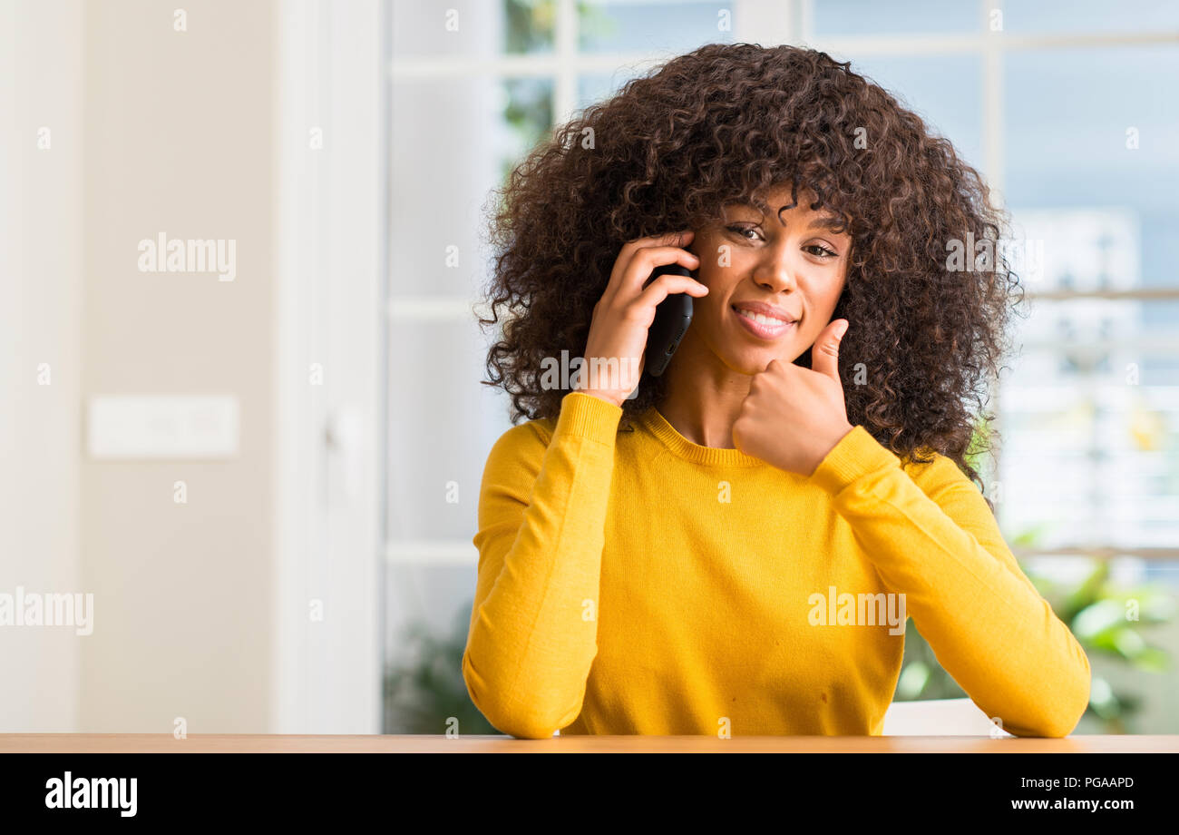 African american woman using smartphone happy with big smile doing ok ...