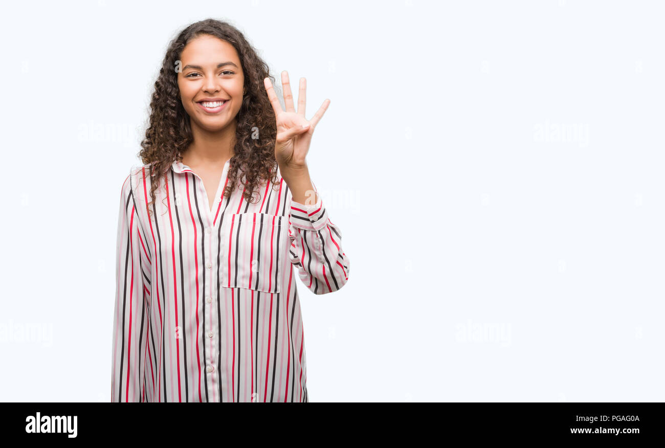 Beautiful young hispanic woman showing and pointing up with fingers ...