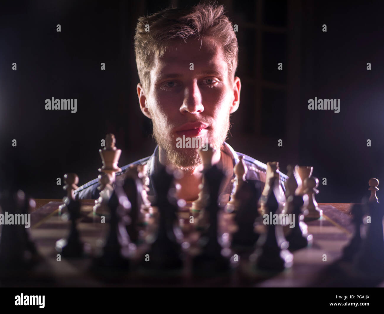 Handsome Male Model Considers His Next Chess Move Stock Photo