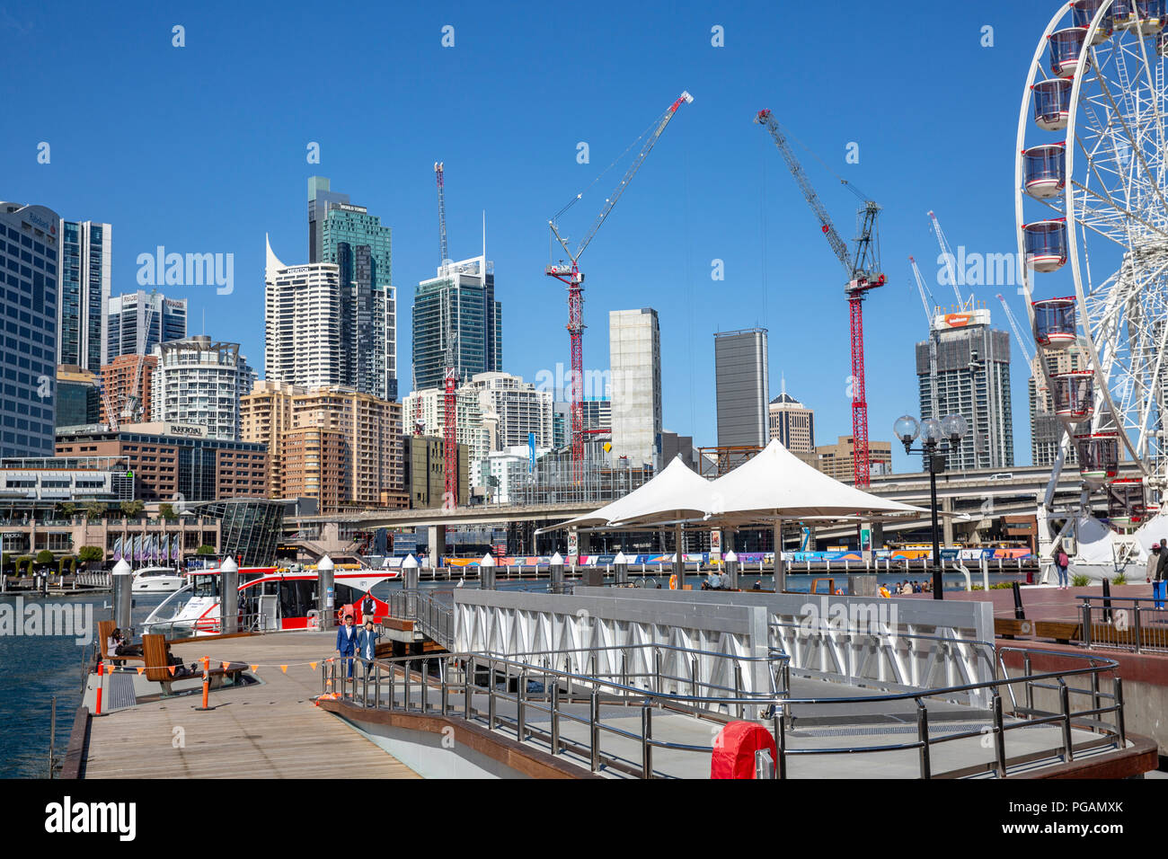 Darling harbour in Sydney city centre, with giant ferris wheel and development work underway,Sydney,New South Wales,Australia Stock Photo