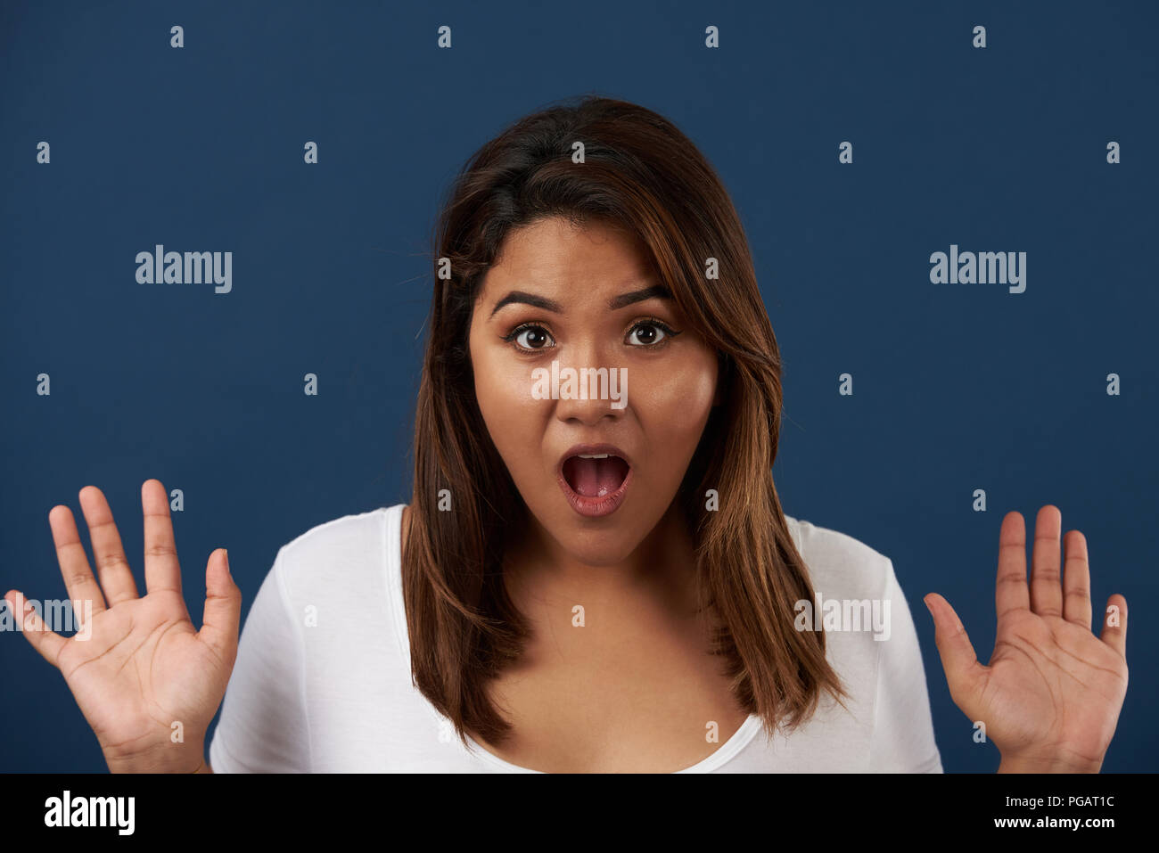 Wow expression of young woman isolated on blue background Stock Photo