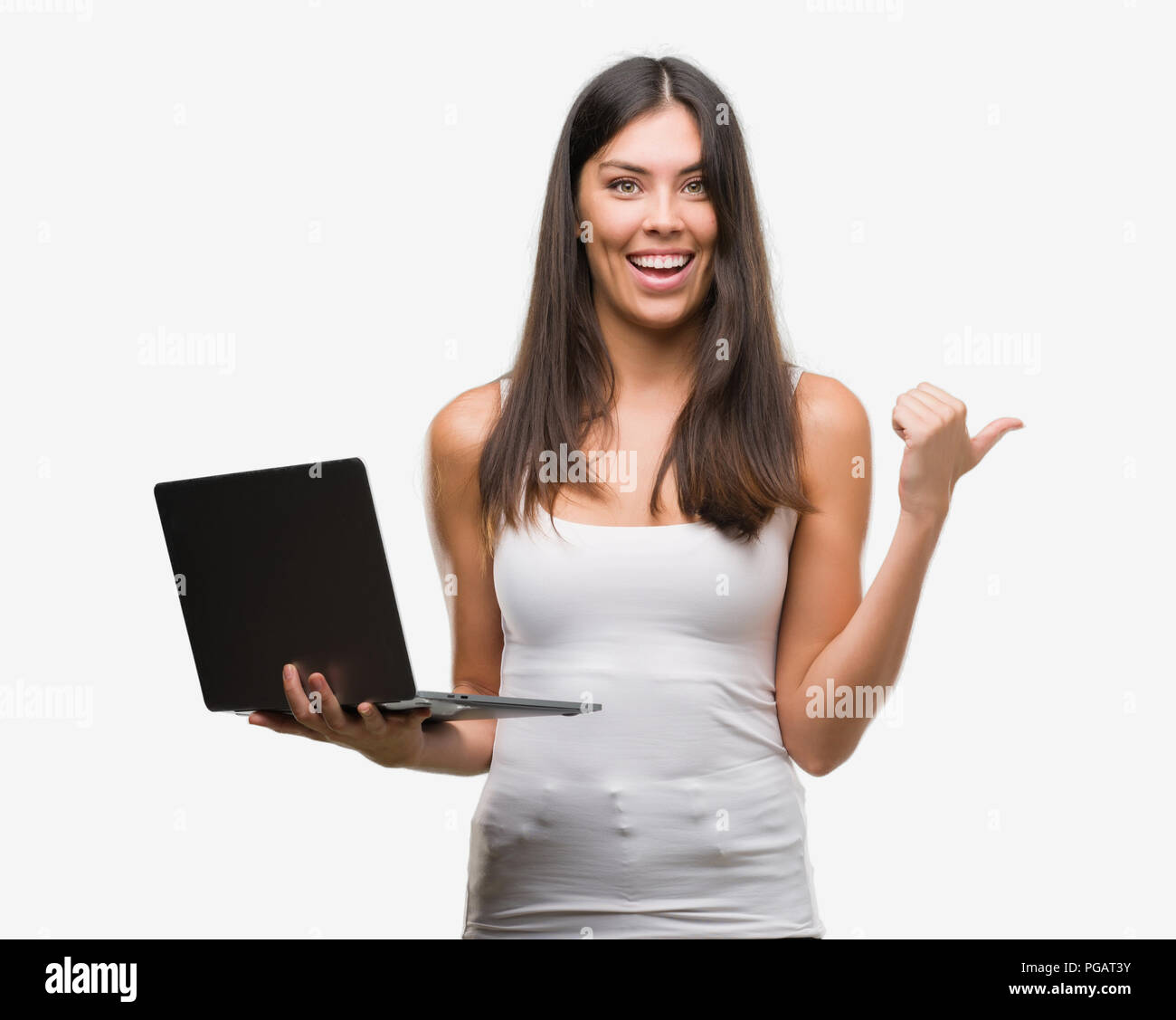 Young hispanic woman using computer laptop pointing and showing with ...