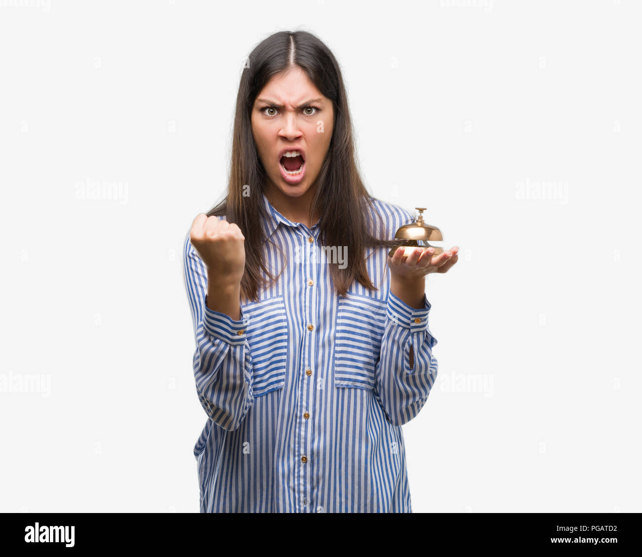 Agressive Bell Ringer Young beautiful hispanic holding hotel ring bell annoyed and frustrated ...