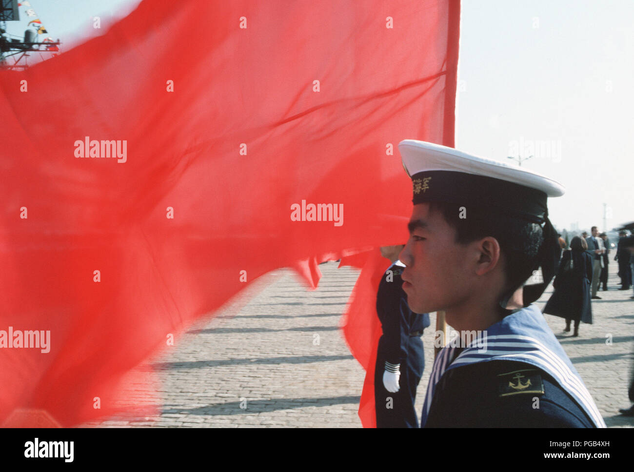 A Chinese sailor parades the Chinese colors during the first visit by US Navy (USN) ships to China in 40 years. Stock Photo