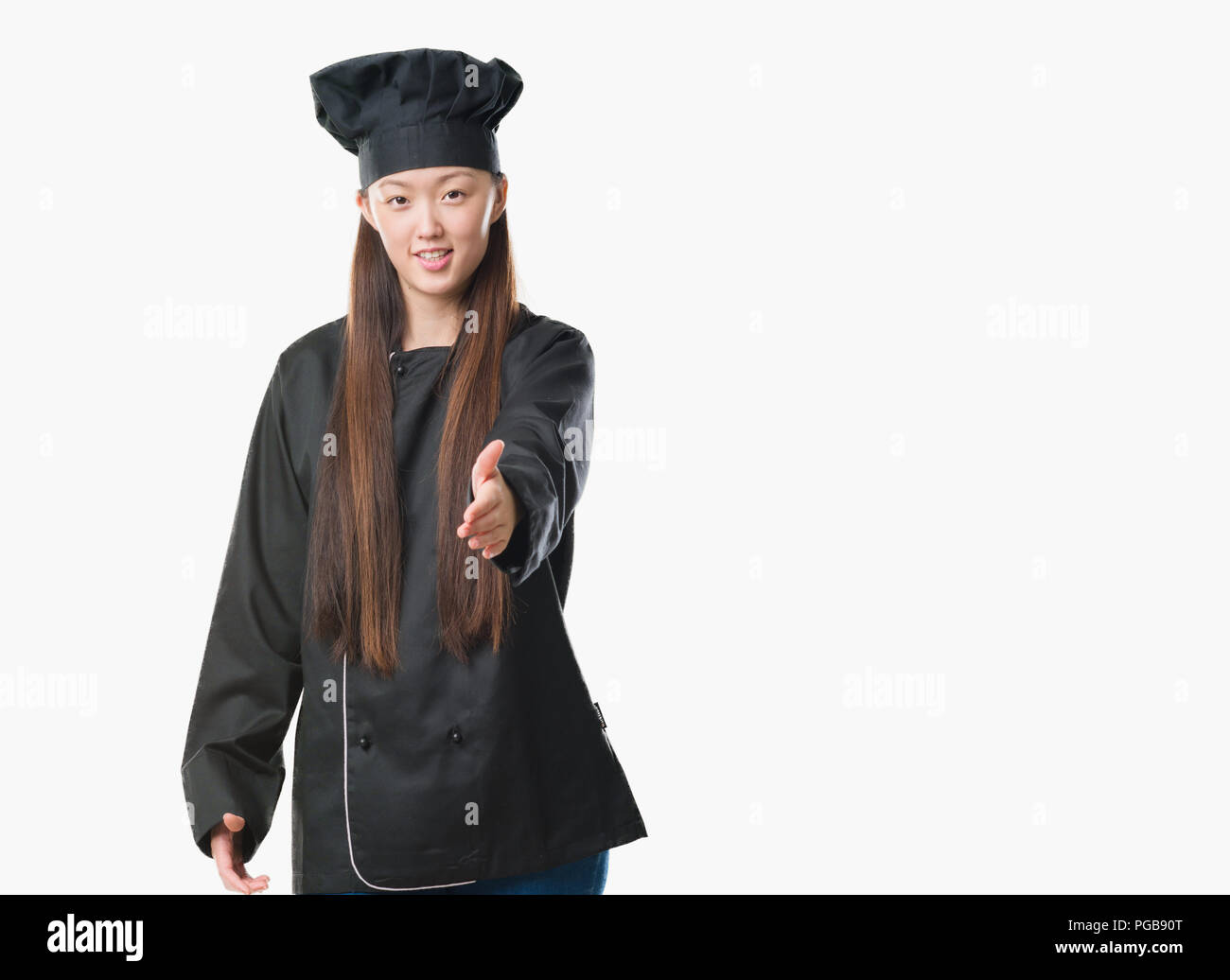 Handshake Chef Young Chinese woman over isolated background wearing chef uniform ...