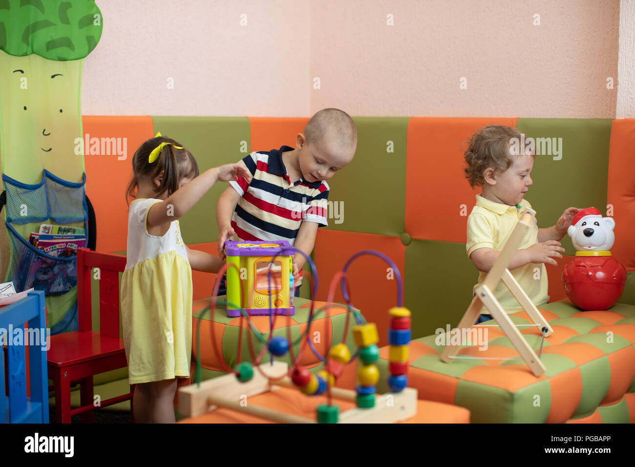 Group of children playing in kindergarten or daycare centre Stock Photo