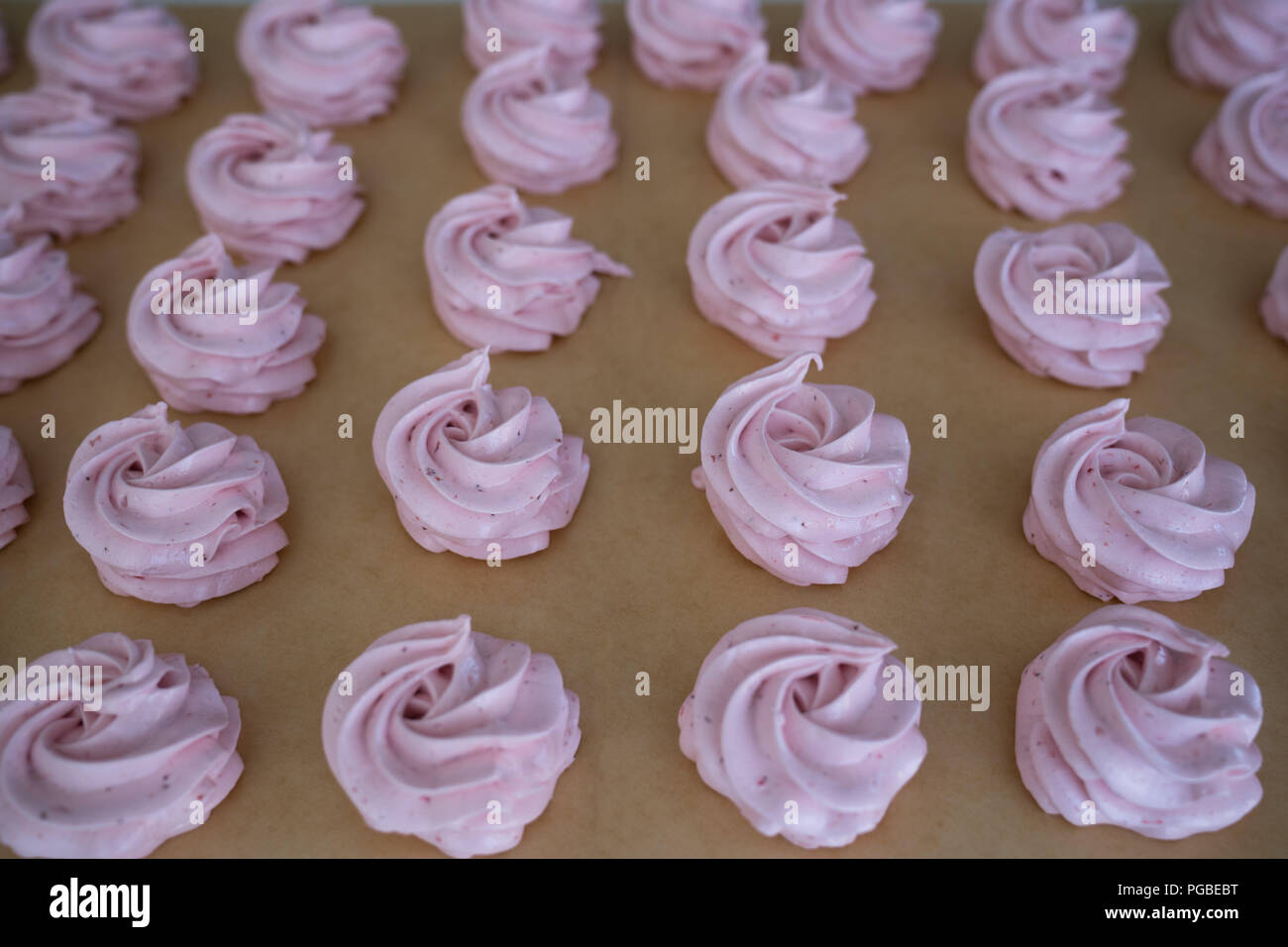 Making French meringue cookies marshmallows on parchment paper Stock