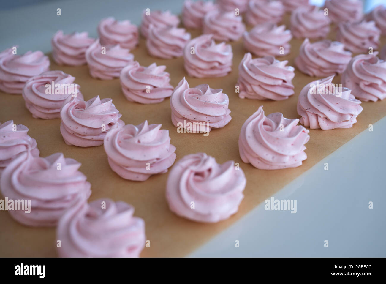 Making French meringue cookies marshmallows on parchment paper Stock