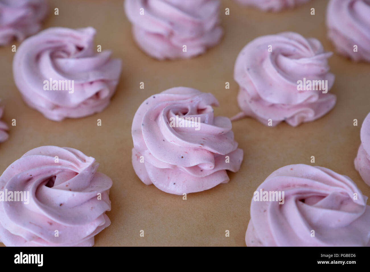 Making French meringue cookies marshmallows on parchment paper Stock