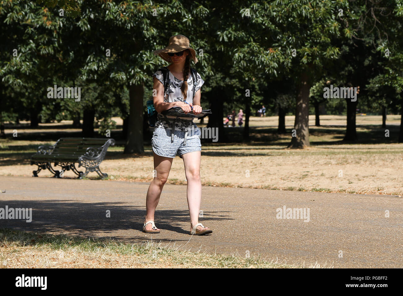 Tourists in Hyde Park on a very hot and humid day in the capital. According  to the Met Office the temperature in London and South East is likely to  reach 35 degree