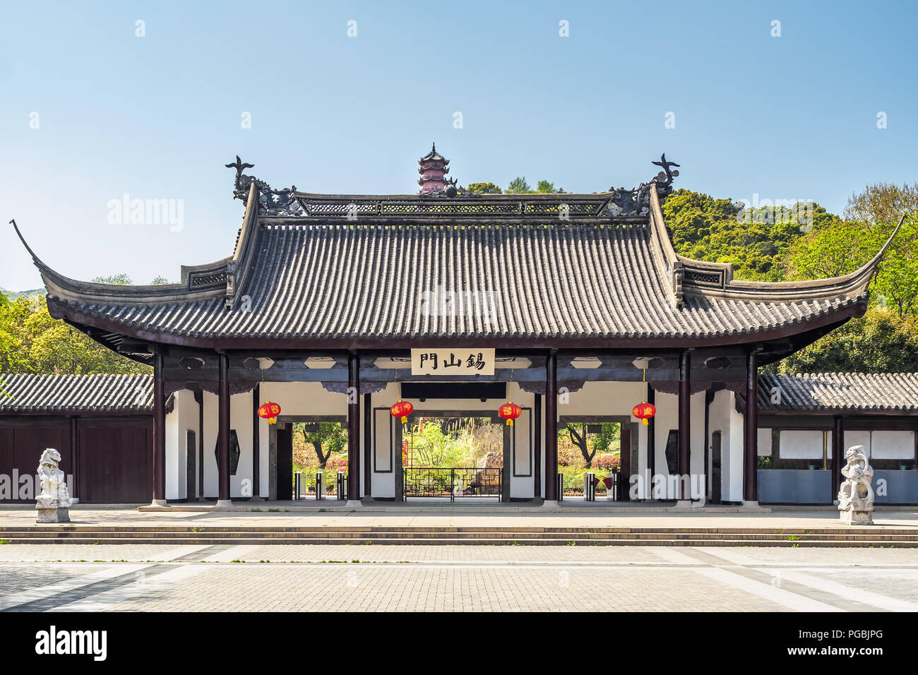 The main entrance of Xihui Park with the Longguang Pagoda in Wuxi, China. (The translation of the text on the gate means 'tin mountain door.') Stock Photo
