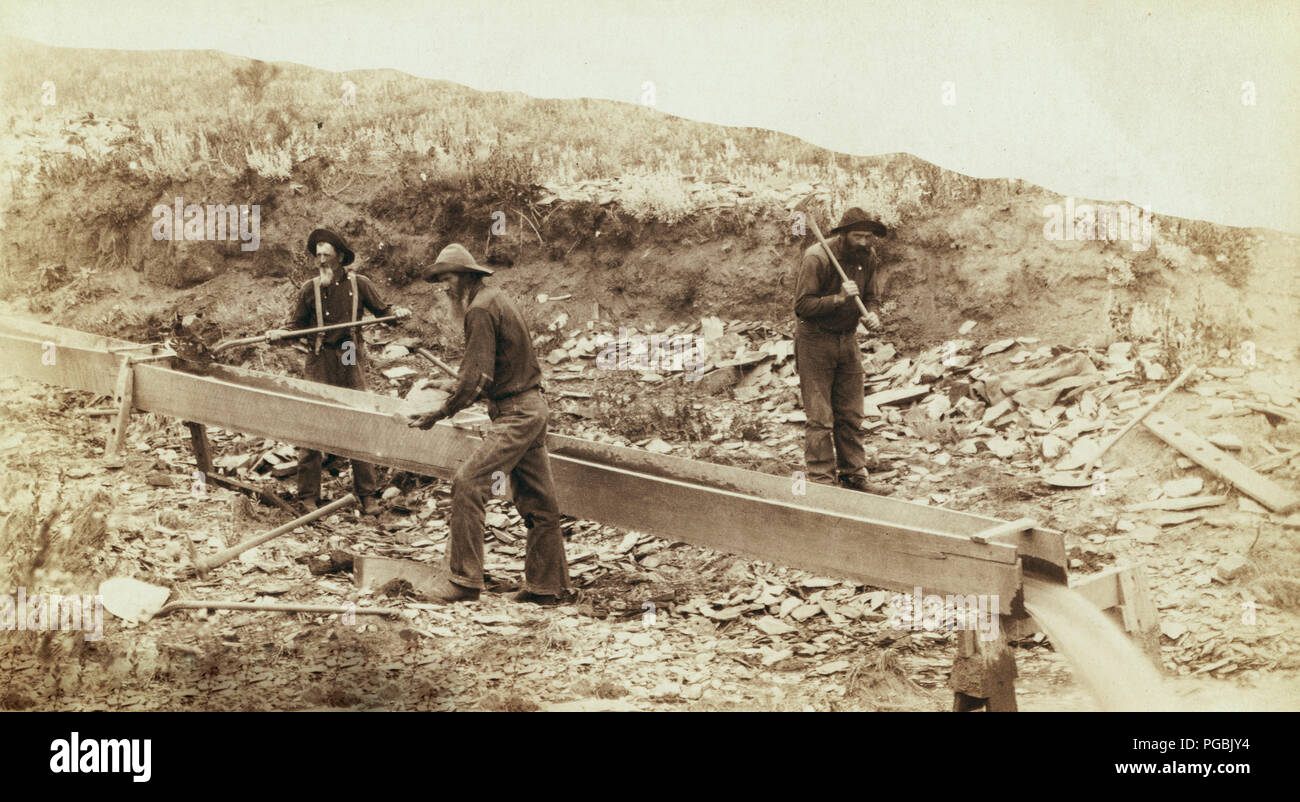 Three men placer mining with shovels, picks and pan Stock Photo Alamy