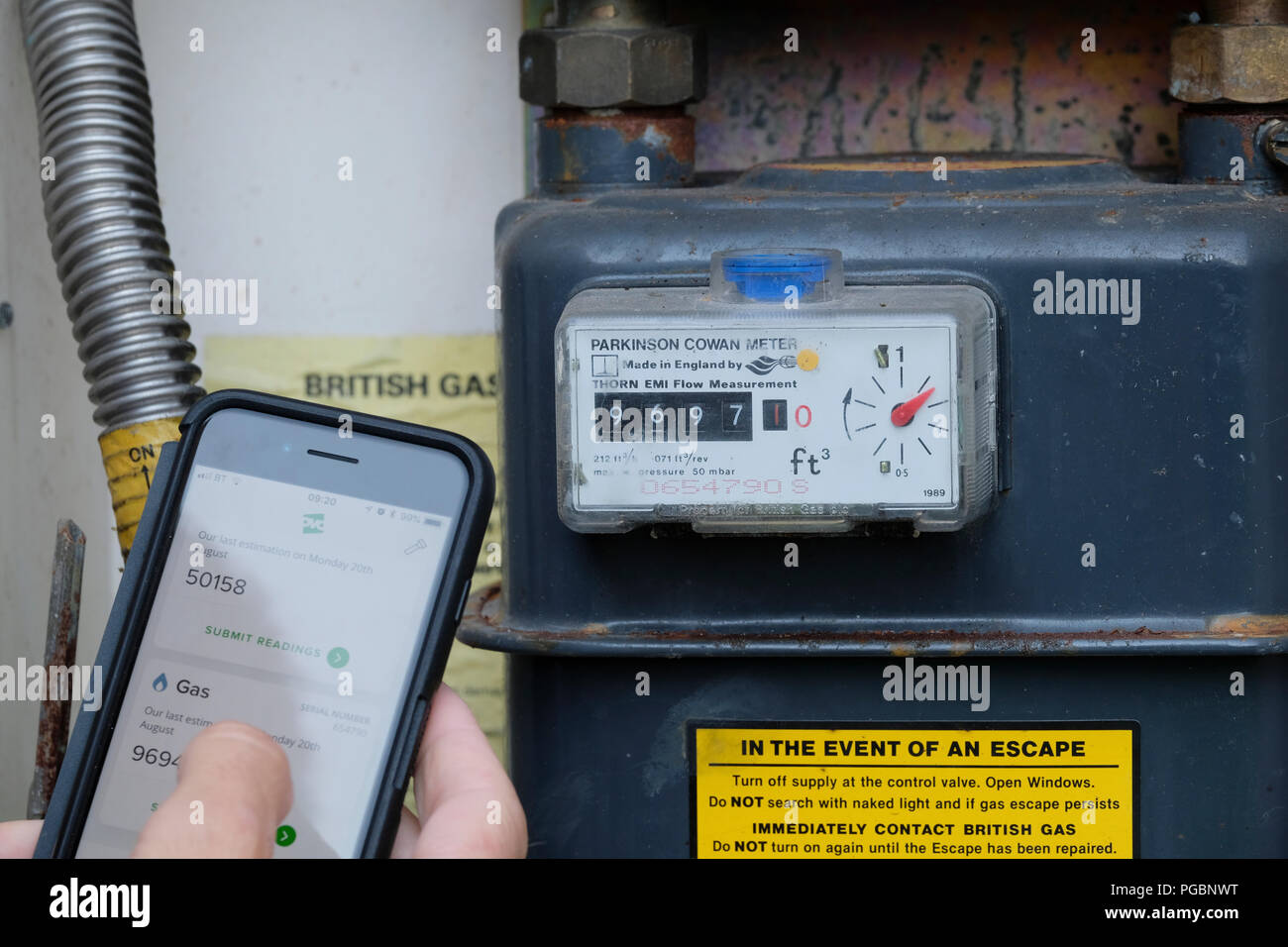 Submitting gas and electric meter reading to energy company using an App on a smart phone Stock Photo