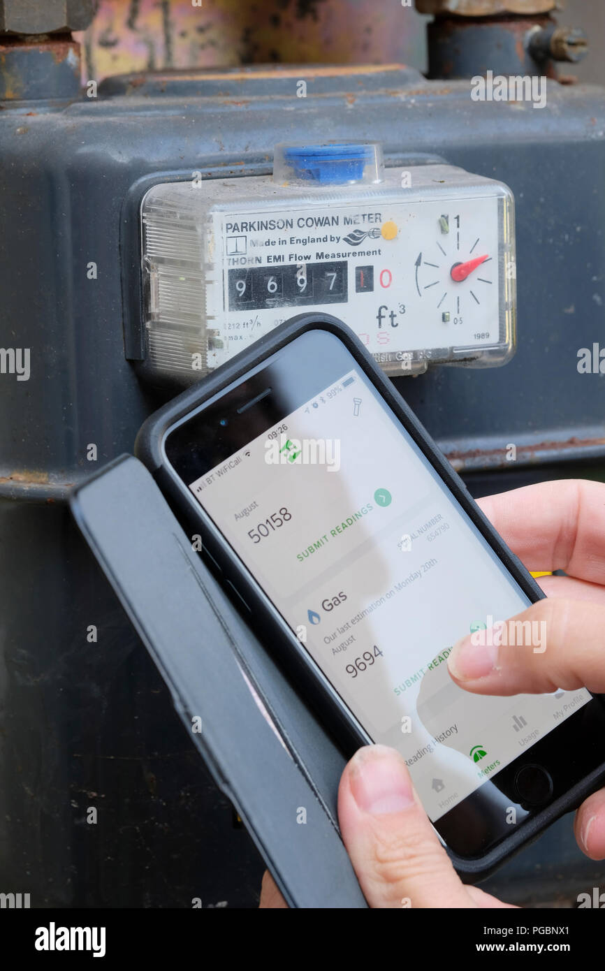Submitting gas and electric meter reading to energy company using an App on a smart phone Stock Photo