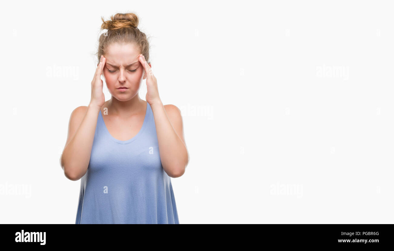 Young blonde woman with hand on head for pain in head because stress. Suffering migraine. Stock Photo
