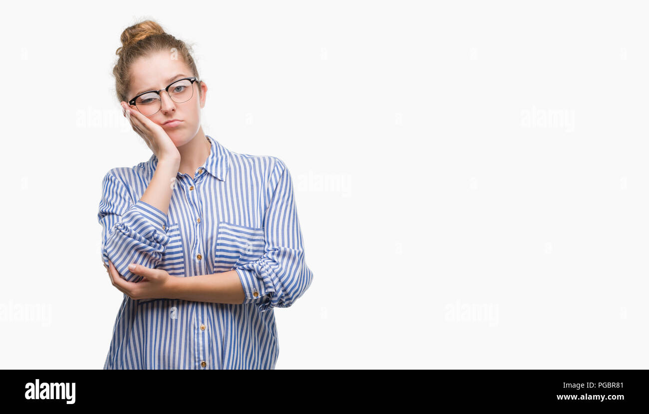 Young blonde business woman thinking looking tired and bored with depression problems with crossed arms. Stock Photo