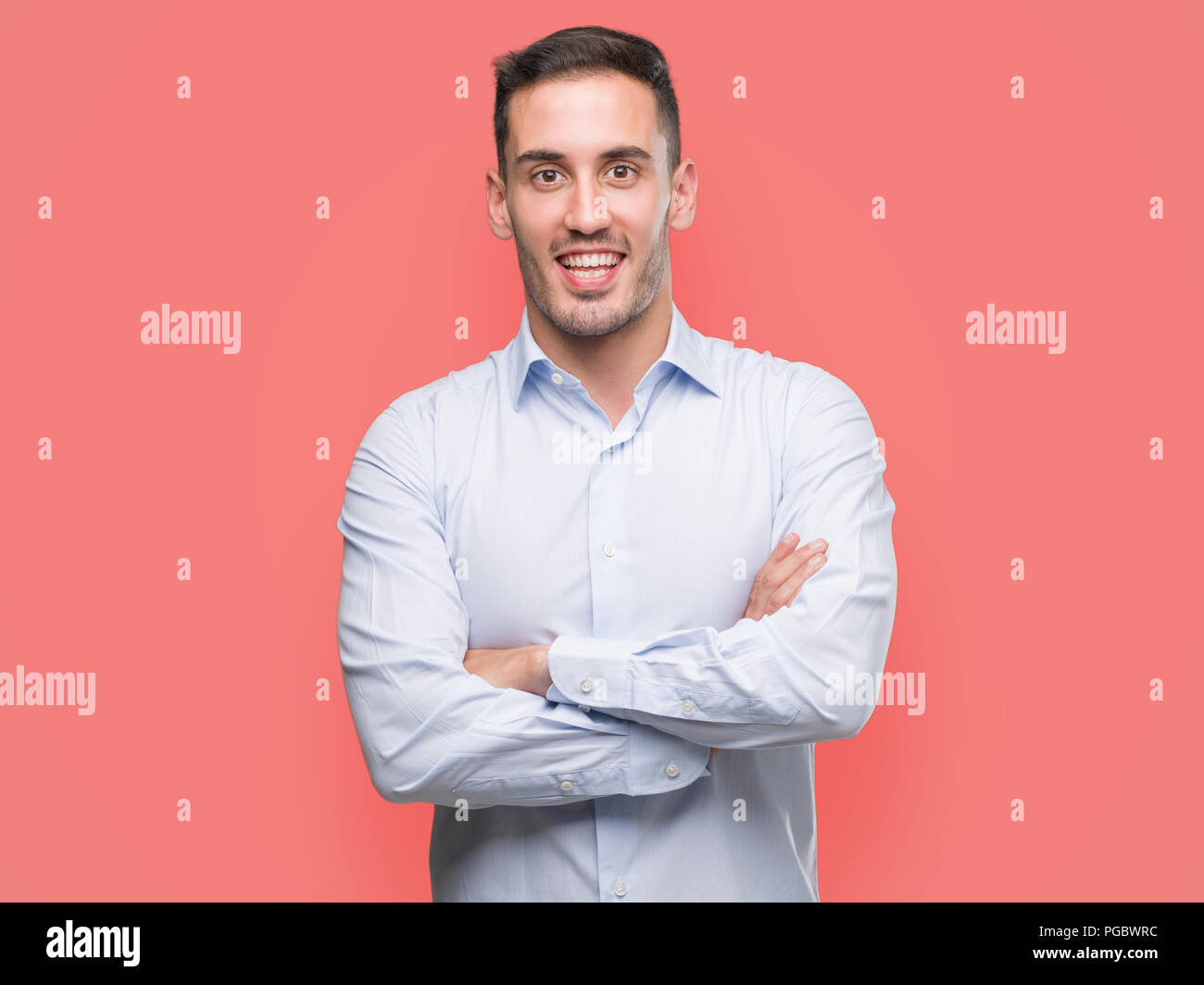 Handsome young businessman happy face smiling with crossed arms looking ...