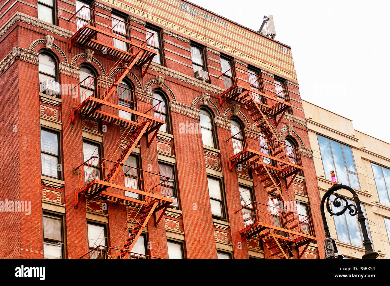 Fire escapes on the exterior of a brick apartment building in New York