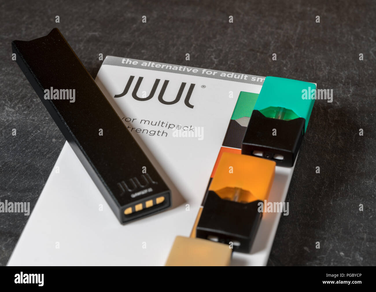 Box holding JUUL nicotine dispenser and pods Stock Photo