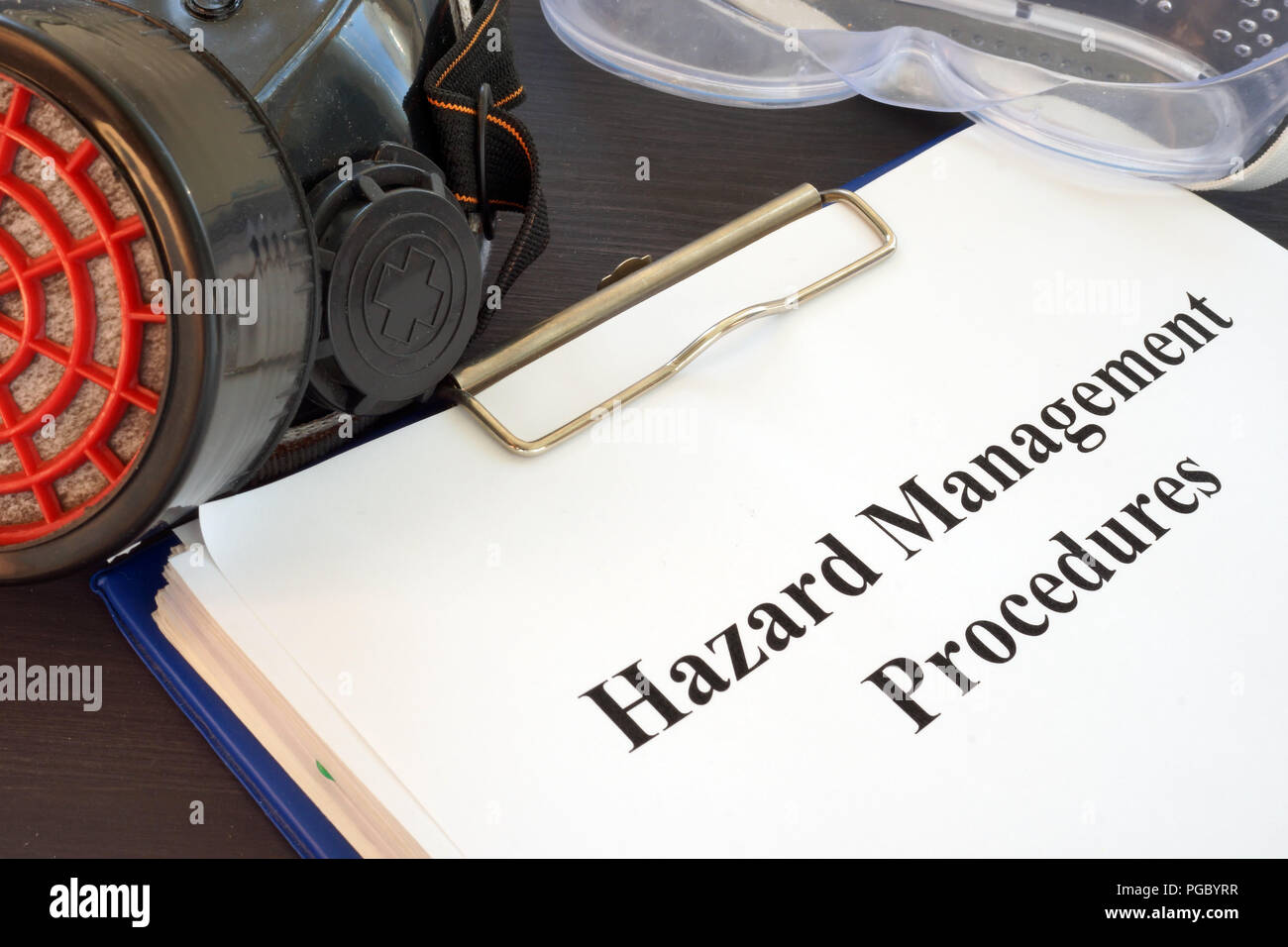 Clipboard with Hazard Management Procedures documents on the desk. Stock Photo