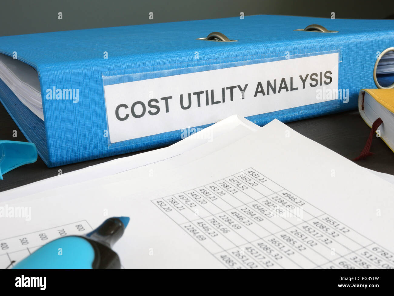 Cost utility analysis CUA documents in the folder. Stock Photo