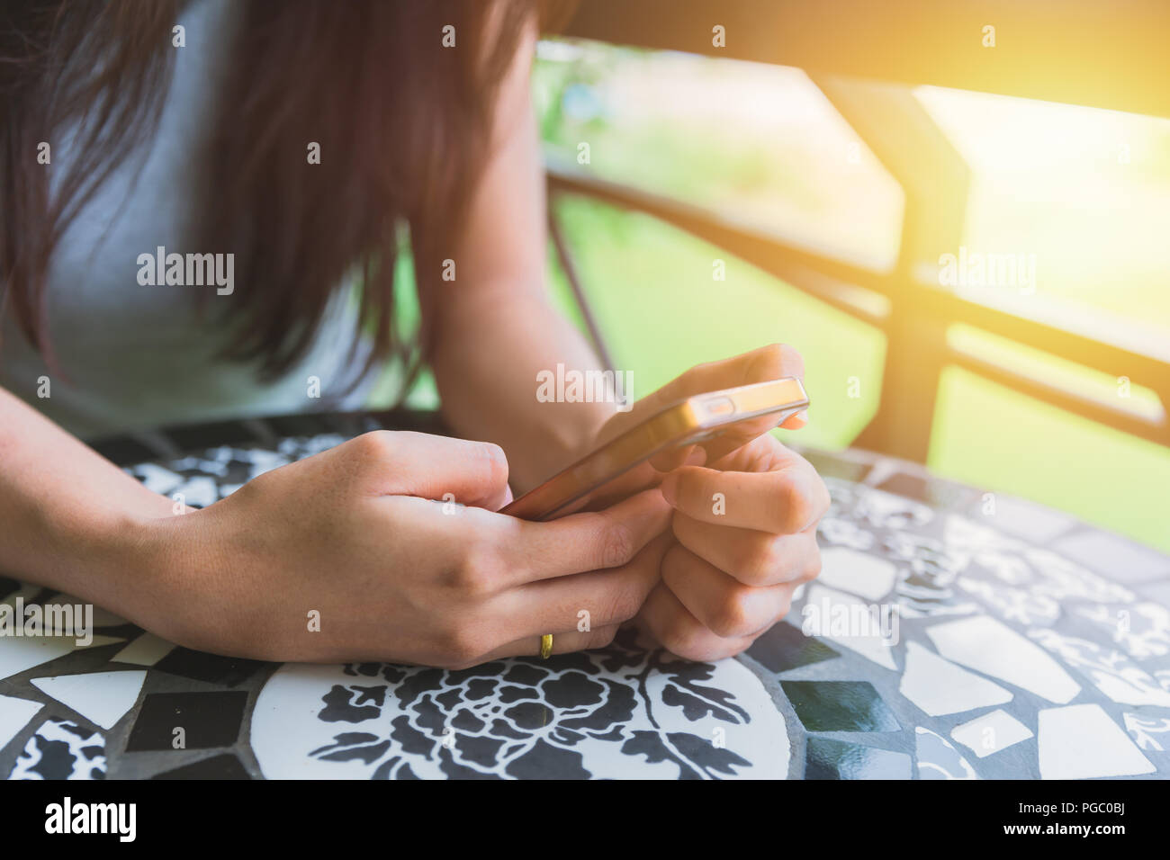 girl sitting using smartphone Stock Photo