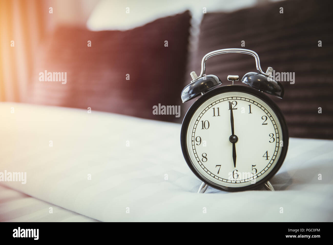 retro clock on bad morning wake up times 6 o'clock in the bedroom Stock Photo