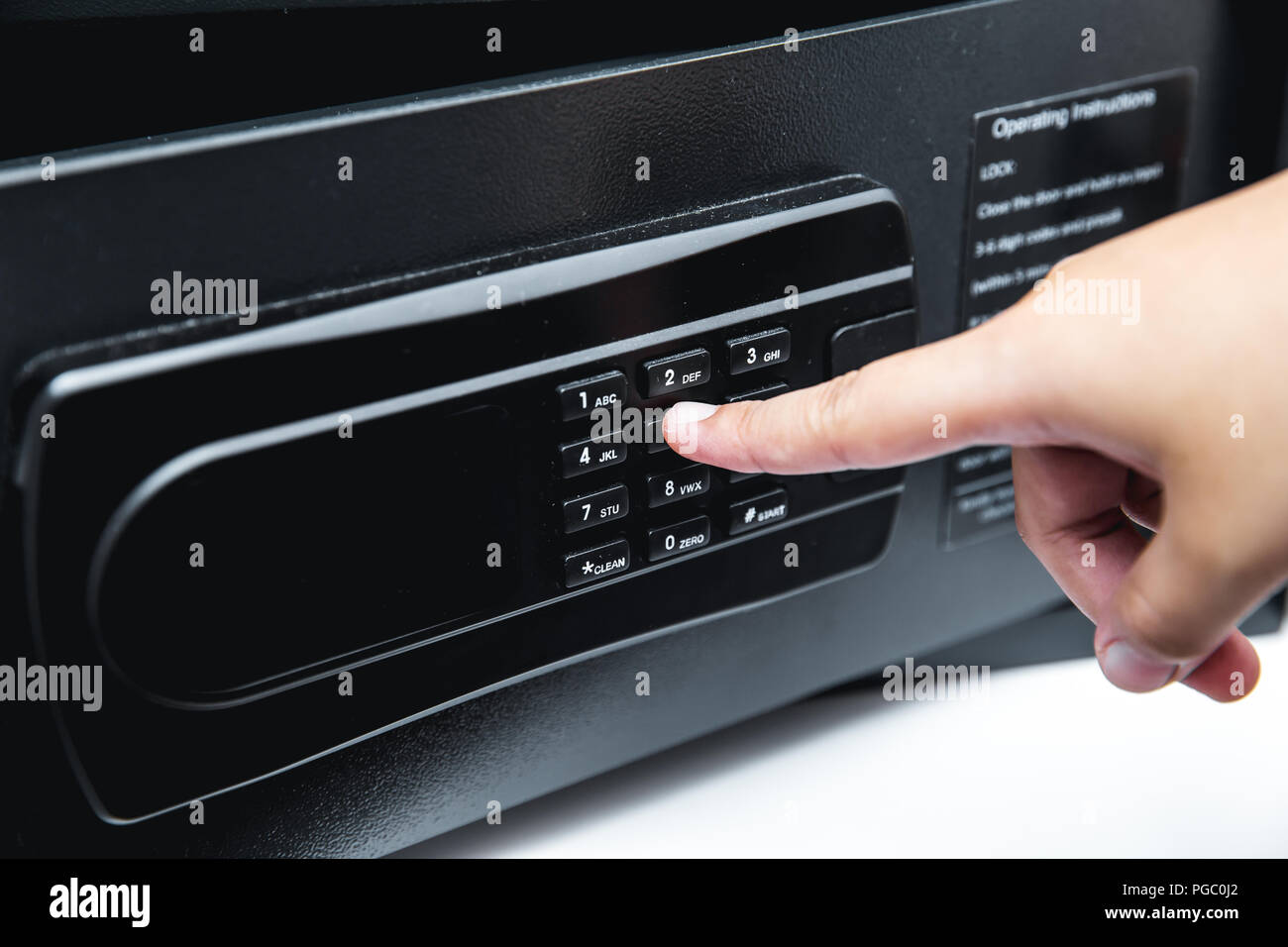 Digital safety safe box in hotel room service with hand using finger at
