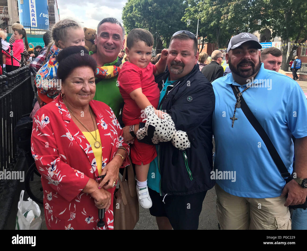 Pat Collins, with her sons Lawrence, Noel and Brendan and grandchildren Tilly and Joseph, as they await the arrival of Pope Francis on Sean McDermott Street in Dublin. Stock Photo