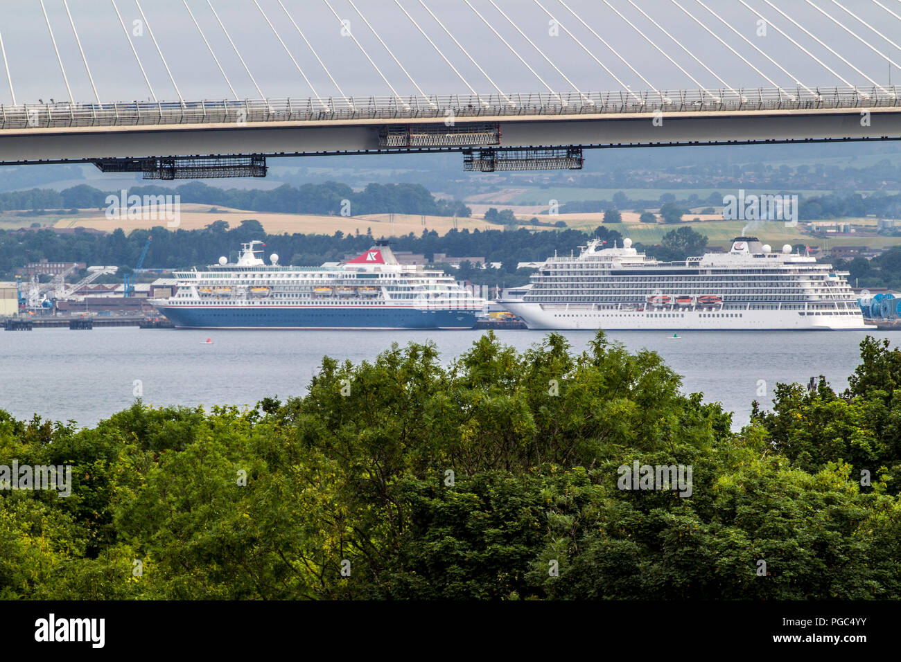 Cruise Ship on river Forth framed by Forth Bridges Stock Photo