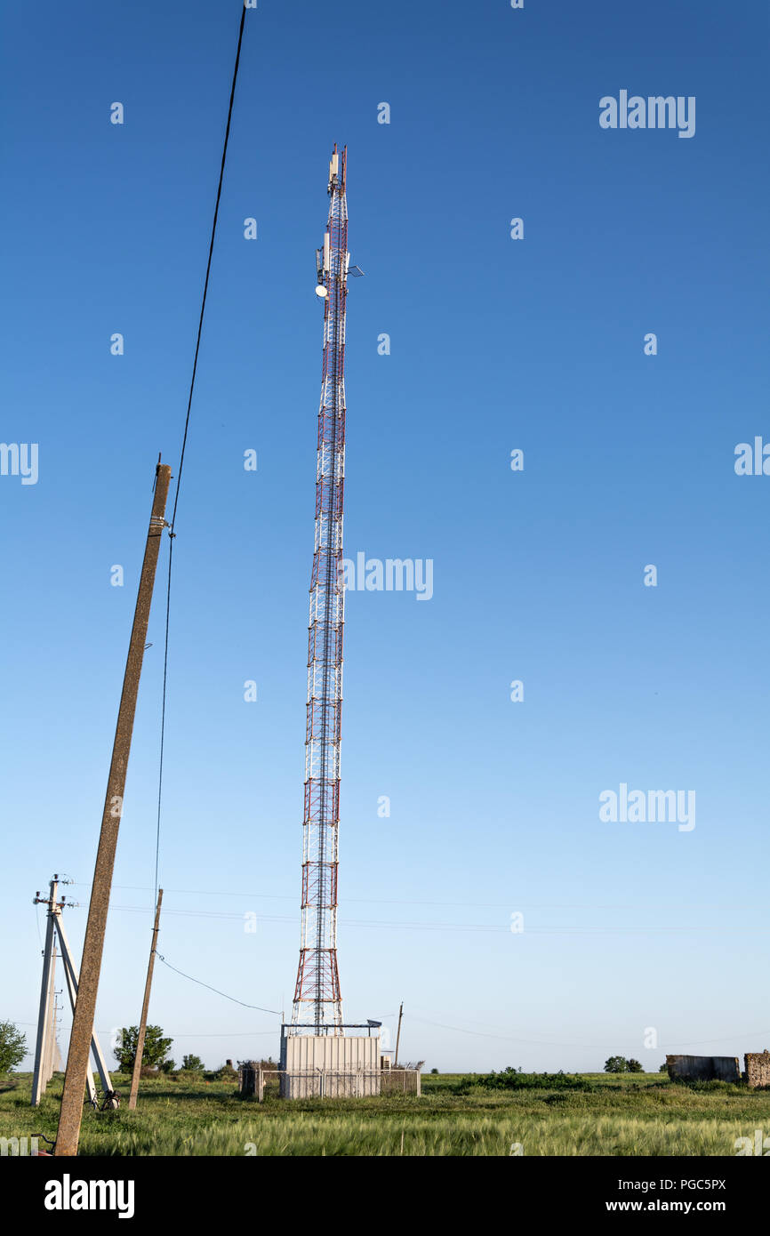 The tower of cellular communication on the background of the blue sky ...