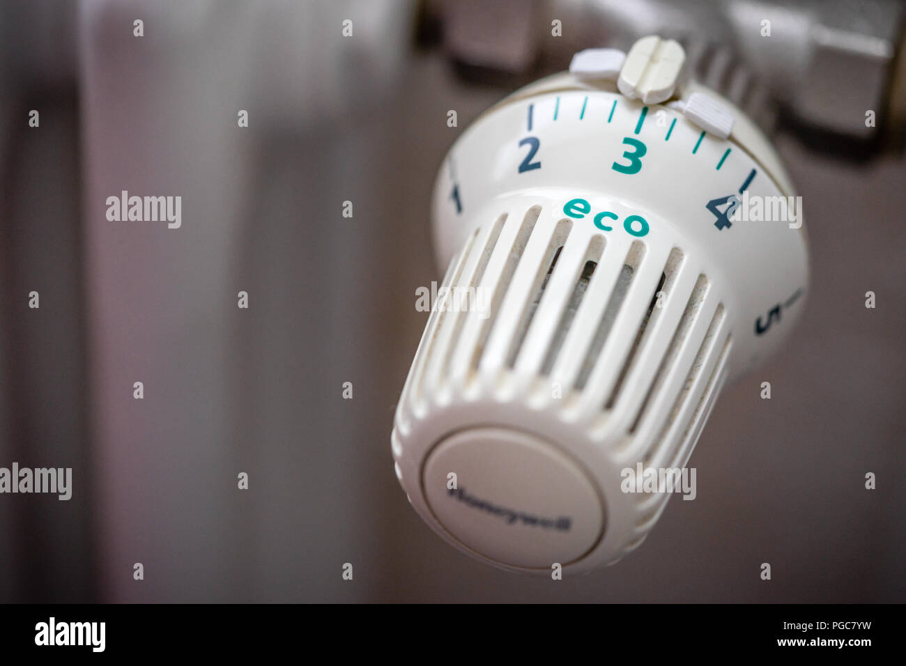 Radiator thermostat valve temperature dial set on energy efficient green eco setting Stock Photo