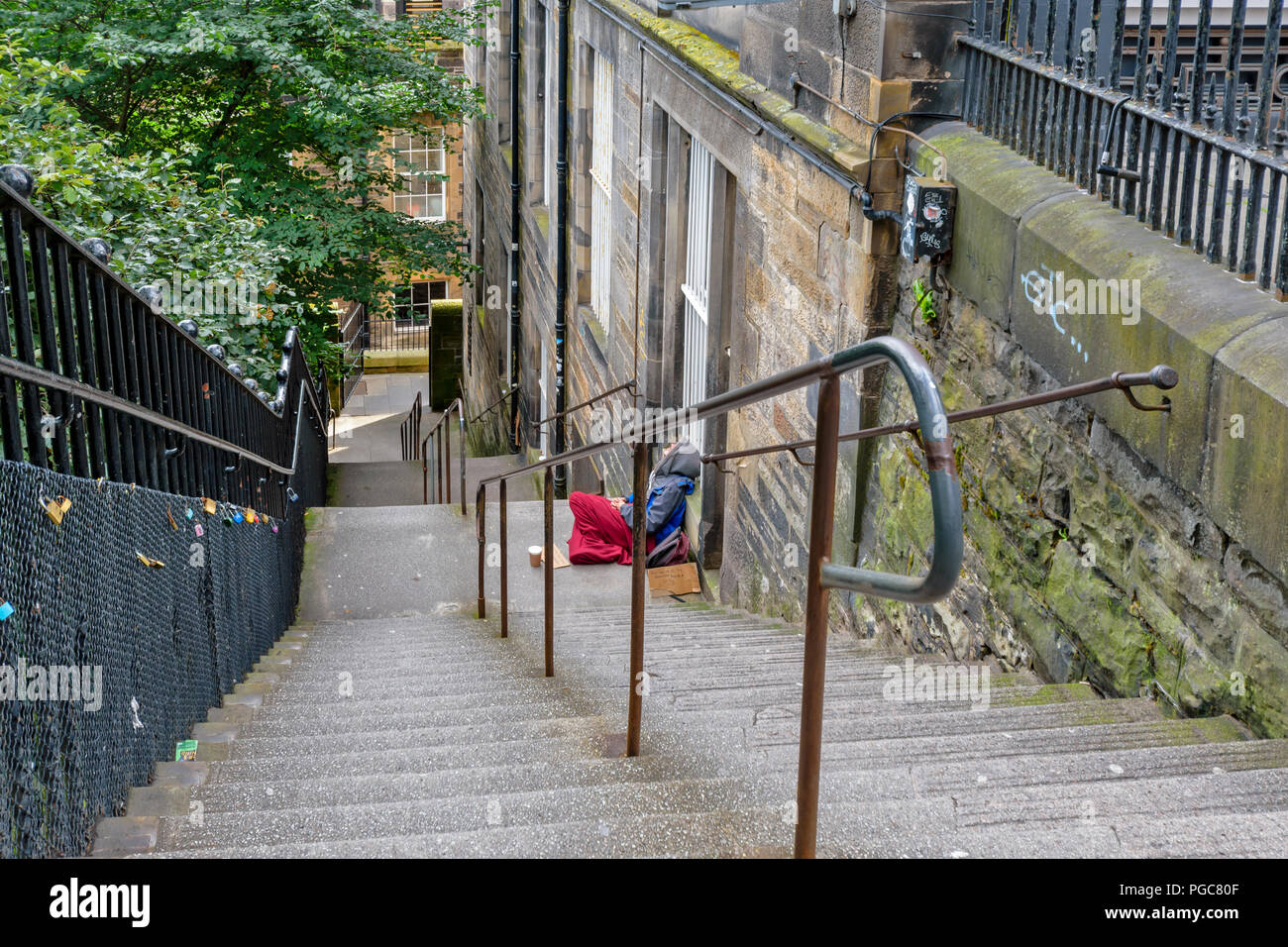 EDINBURGH SCOTLAND HOMELESS ON THE STEPS AND LOVE LOCKS ON THE GRID