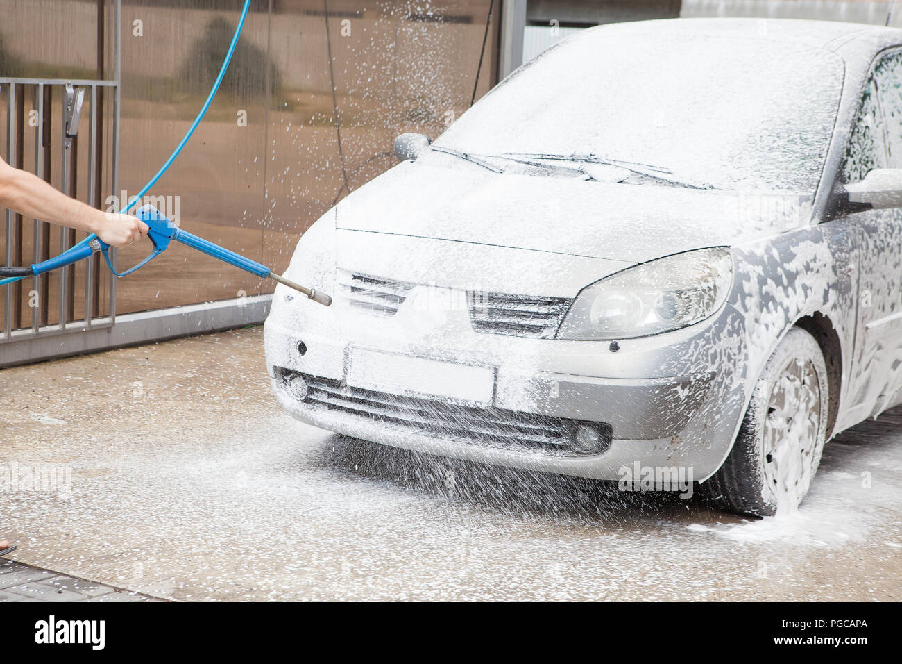 Car wash with foam in car wash station. Carwash. Washing machine at the