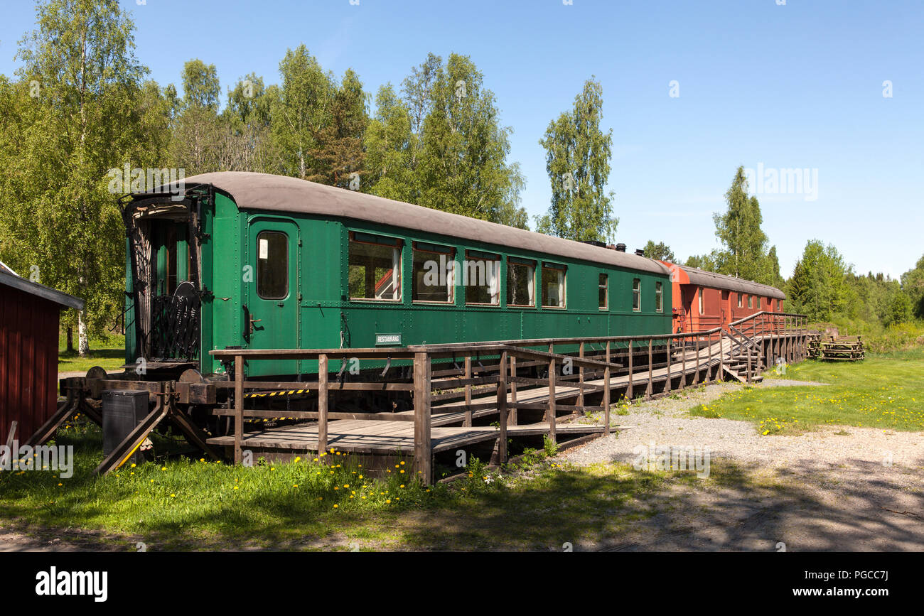 PERSHYTTAN, SWEDEN ON MAY 18, 2018. View of disposed, culled wagon. Cabin and information board. Editorial use. Stock Photo