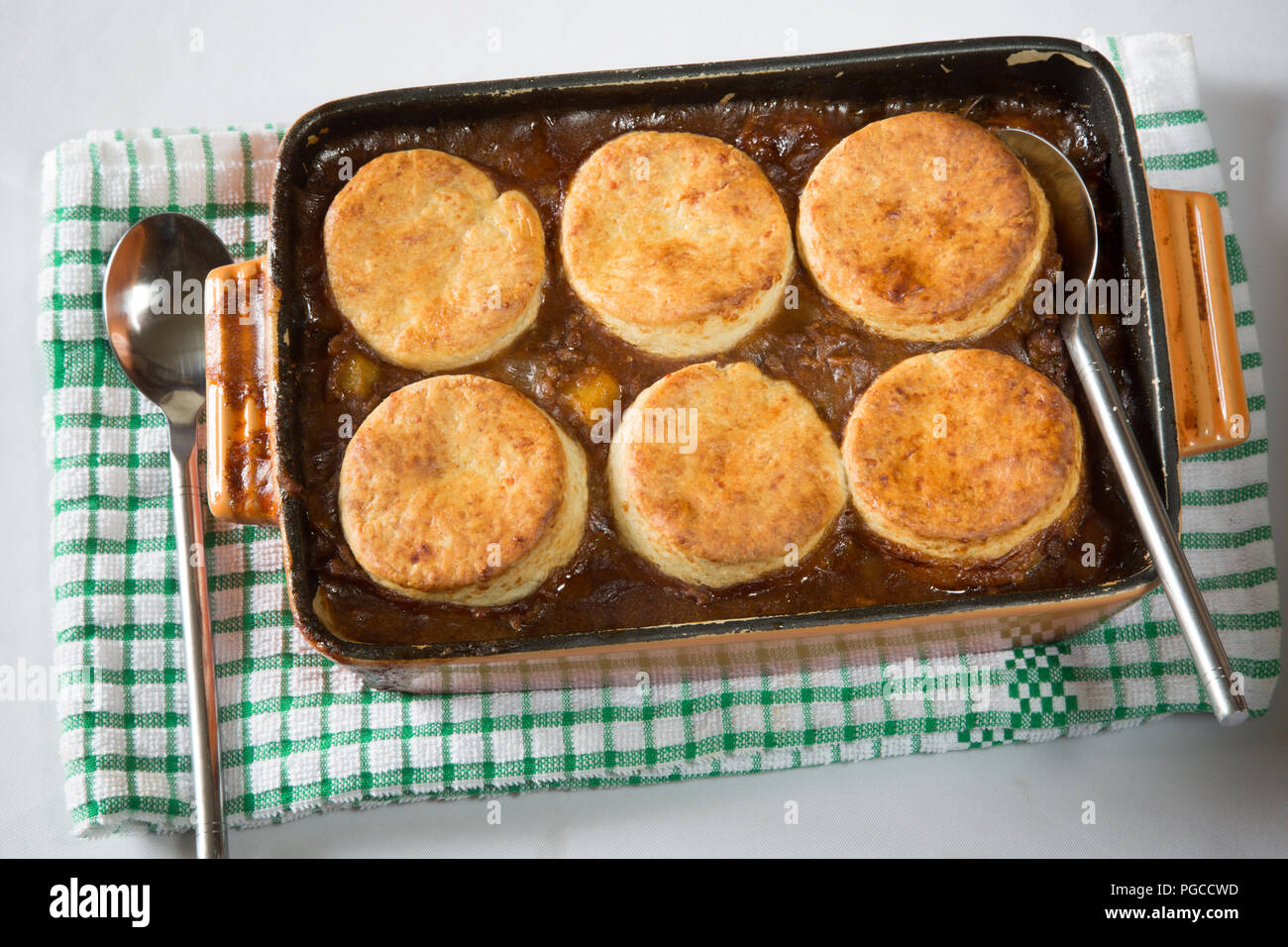 Savoury/Savory minced Beef stew topped with cheese scones in an oven