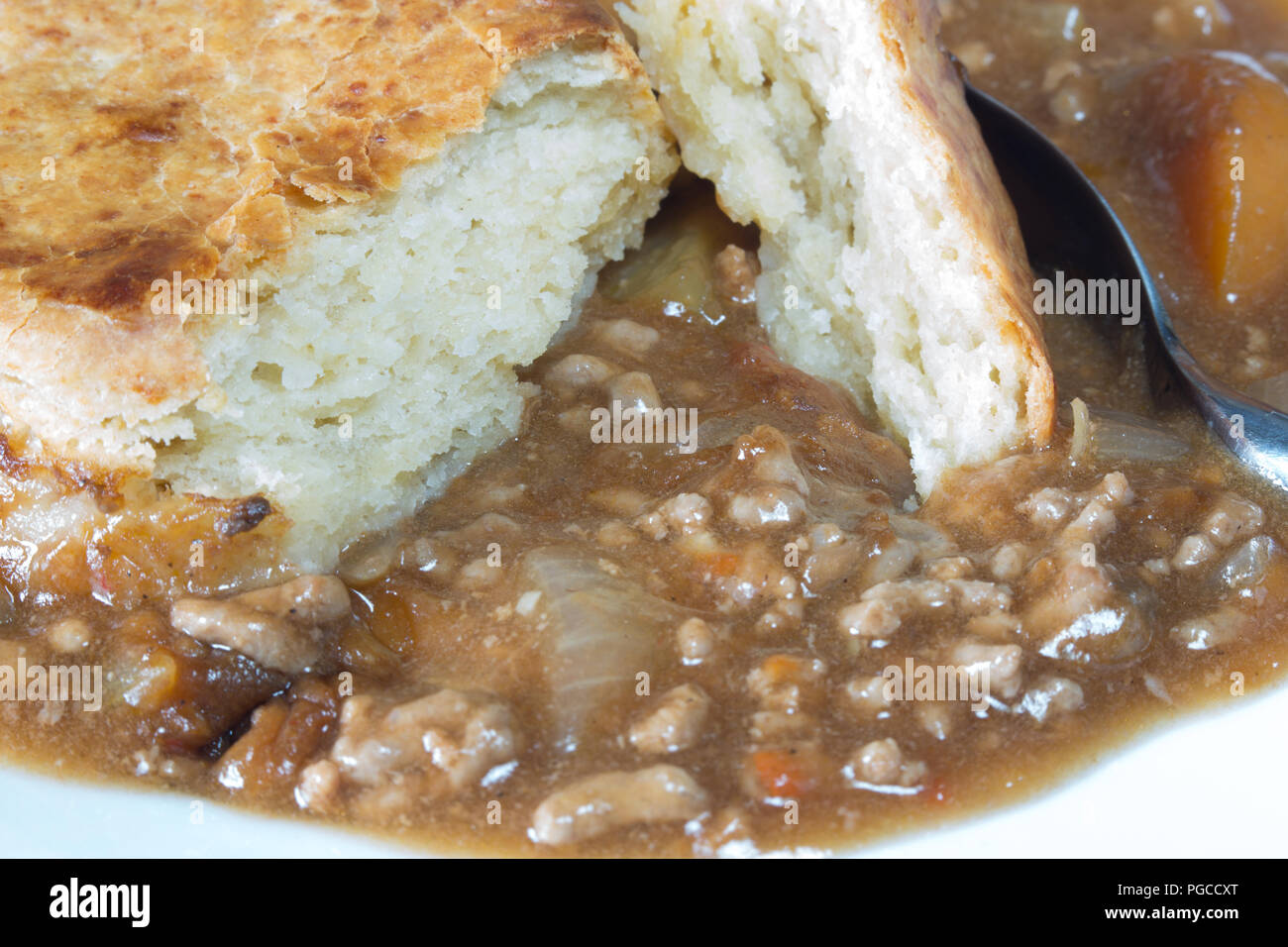 An English pub dish of beef cobbler. Savoury minced beef stew topped