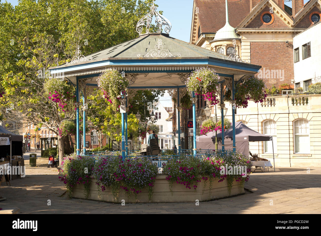 The floral displays around the bandstand in the Carfax of Horsham town center. Summer flowers in hanging baskets. Stock Photo