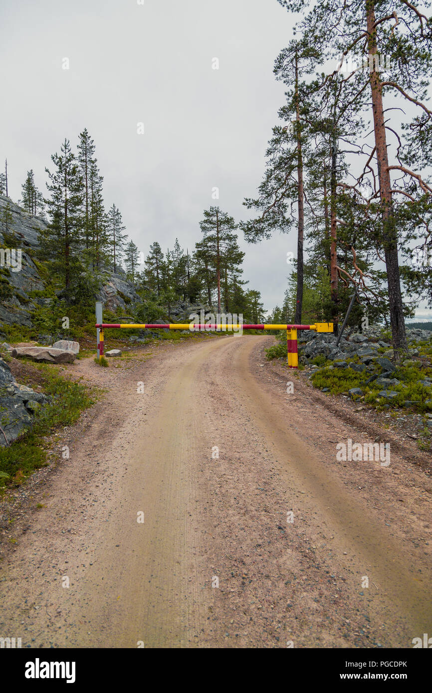 Luosto Finland, unpaved road closed in the forest Stock Photo