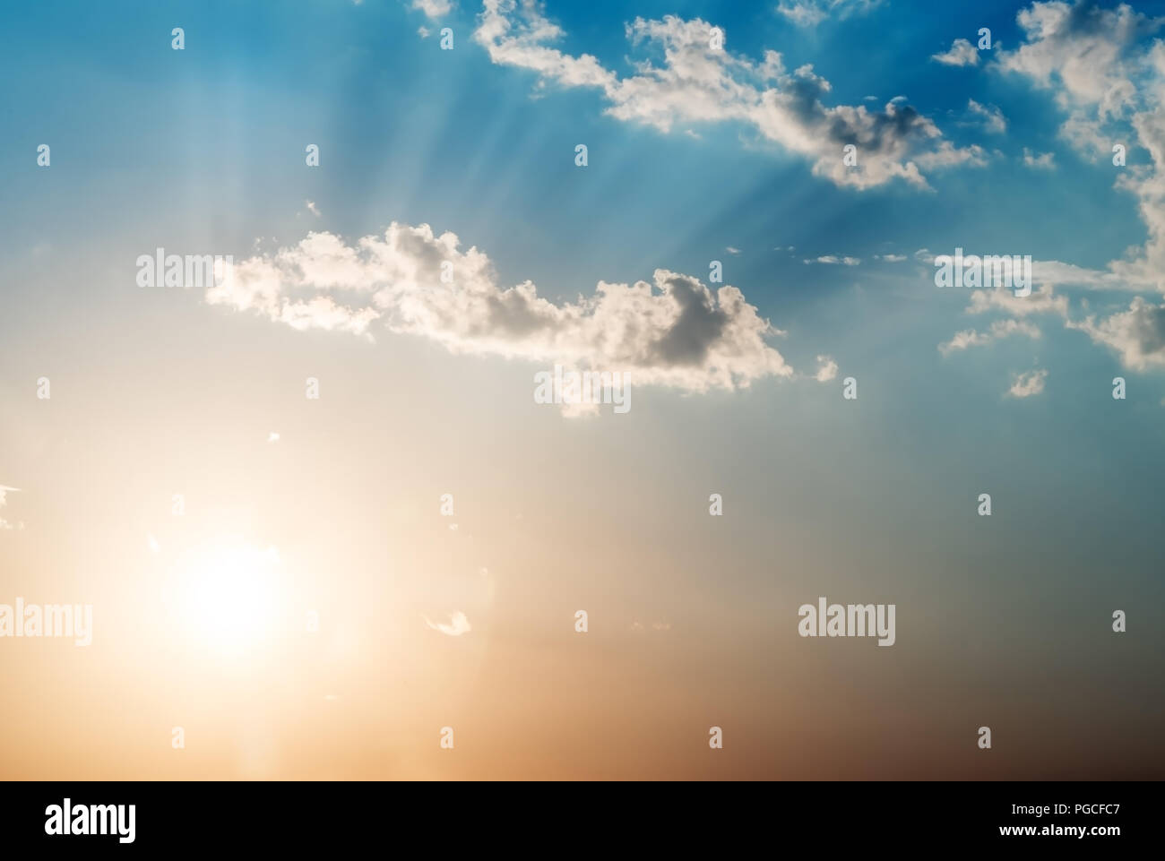 Beautiful clouds on the sky and the sun with rays Stock Photo