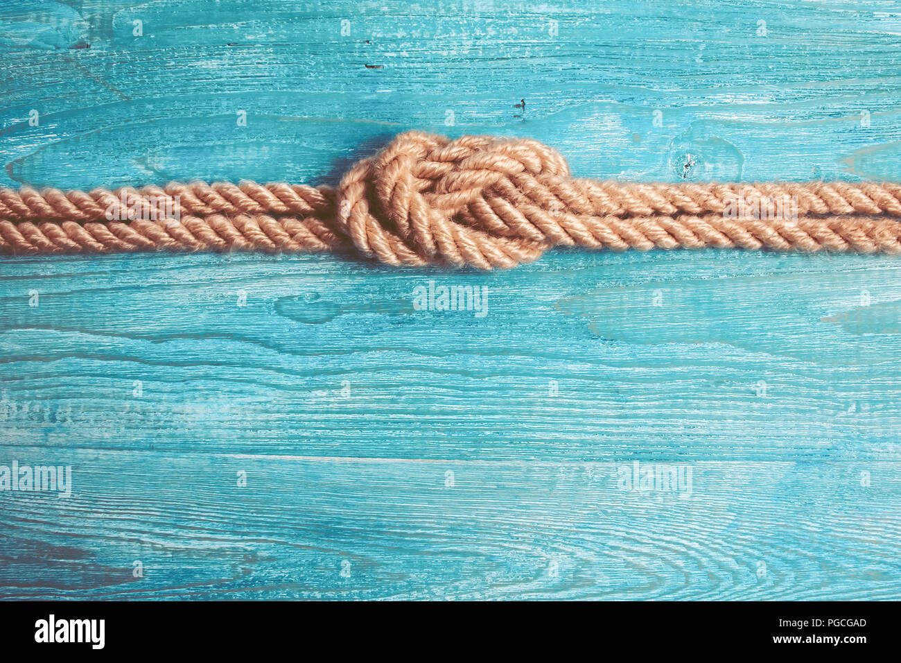 Rope, knot and wooden background Stock Photo