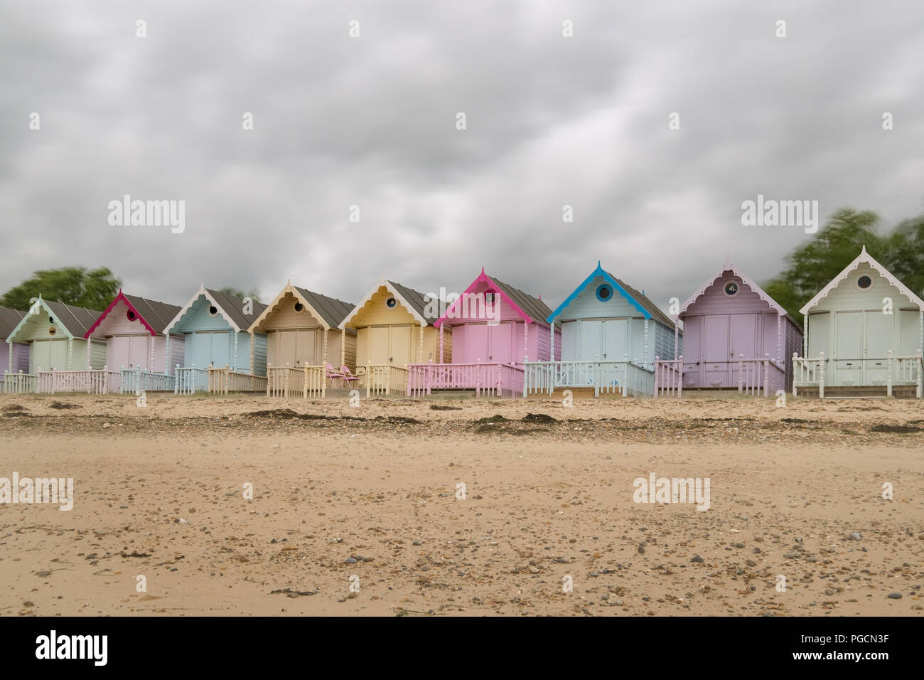 Colourful Beach Huts on the Beach on Mersea Island, Essex. Stock Photo