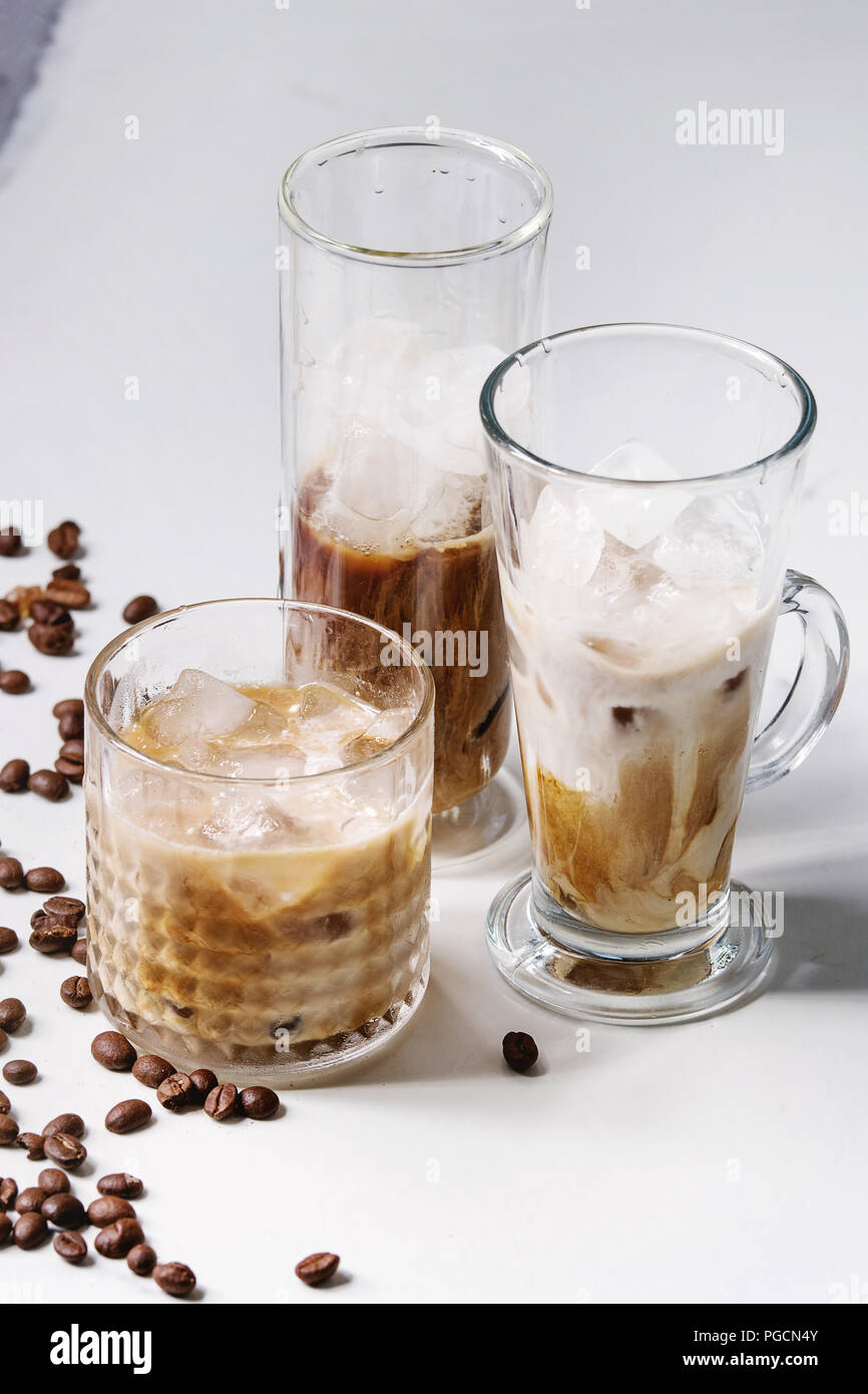 Iced coffee cocktail or frappe with ice cubes and cream served in three ...