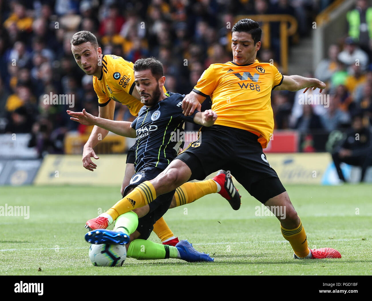 Wolverhampton, UK. 25th Aug 2018. Diogo Jota and Raul Jiminez of Wolverhampton Wanderers crowd out Bernado Silva of Manchester City during the Premier League match between Wolverhampton Wanderers and Manchester City at Molineux on August 25th 2018 in Wolverhampton, England. (Photo by John Rainford/phcimages.com) Credit: PHC Images/Alamy Live News Stock Photo