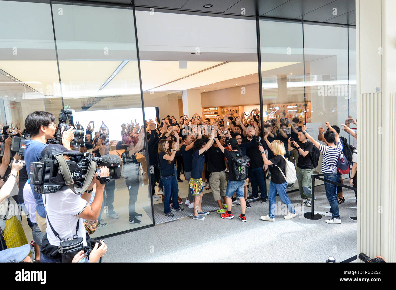 Locals and tourists enter the Kyoto Apple Store on the city's main shopping street on 25th August, 2018 — the store's first day of business. Stock Photo