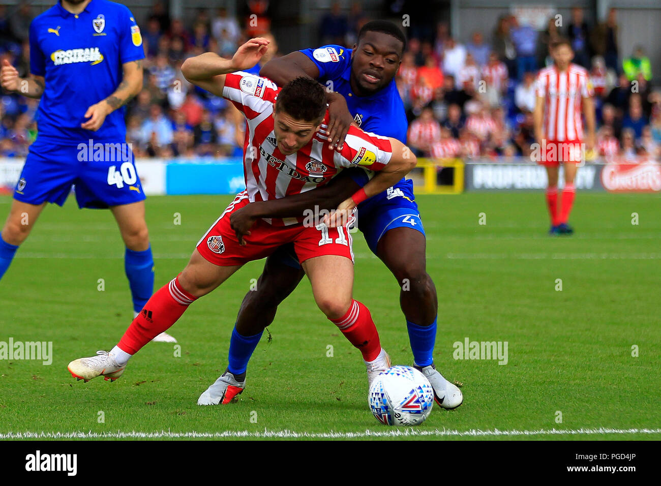 Surrey, UK. 25th Aug 2018. Deji Oshilaja of AFC Wimbledon (R) fouls Lynden Gooch of Sunderland (L). EFL Skybet football league one match, AFC Wimbledon v Sunderland at the Cherry Red Records Stadium in Kingston upon Thames, Surrey on Saturday 25th August 2018. this image may only be used for Editorial purposes. Editorial use only, license required for commercial use. No use in betting, games or a single club/league/player publications. pic by Steffan Bowen/Andrew Orchard sports photography/Alamy Live news Stock Photo
