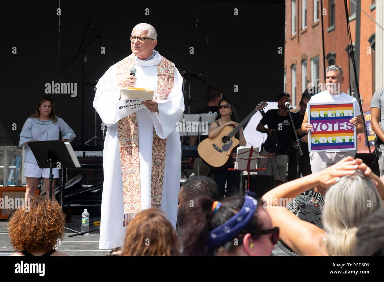 Jersey City, USA.  25th August, 2018:    A Priest gives a speech on the main stage during the 18th Annual Jersey City LGBT Pride Festival in Jersey City, USA.  Credit:  Jonathan Carroll/Alamy Live News Stock Photo