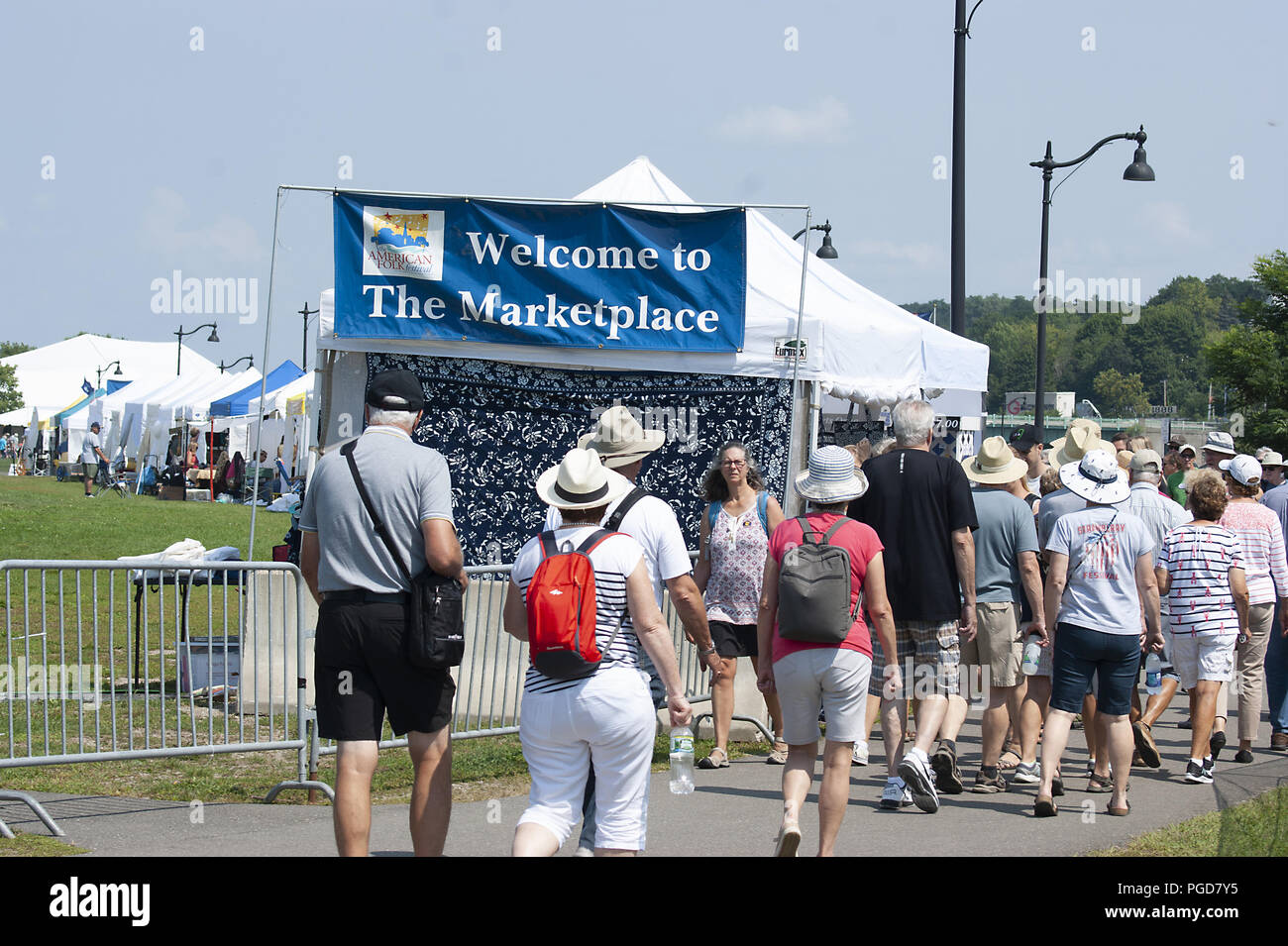 Bangor, Maine, USA.25th August, 2018. Crowds at the American Folk Festival. This festival was named one of the world's best music festivals by Conde Nast Traveller. Located on the banks of the Penobscot River, the weather is almost always perfect, with a cool breeze and sunny skies. Tourists come from all over the world to listen to a variety of folk music, shop for crafts at the markeplace  and sample great food. Credit: Janet S. Robbins/Alamy Live News Stock Photo