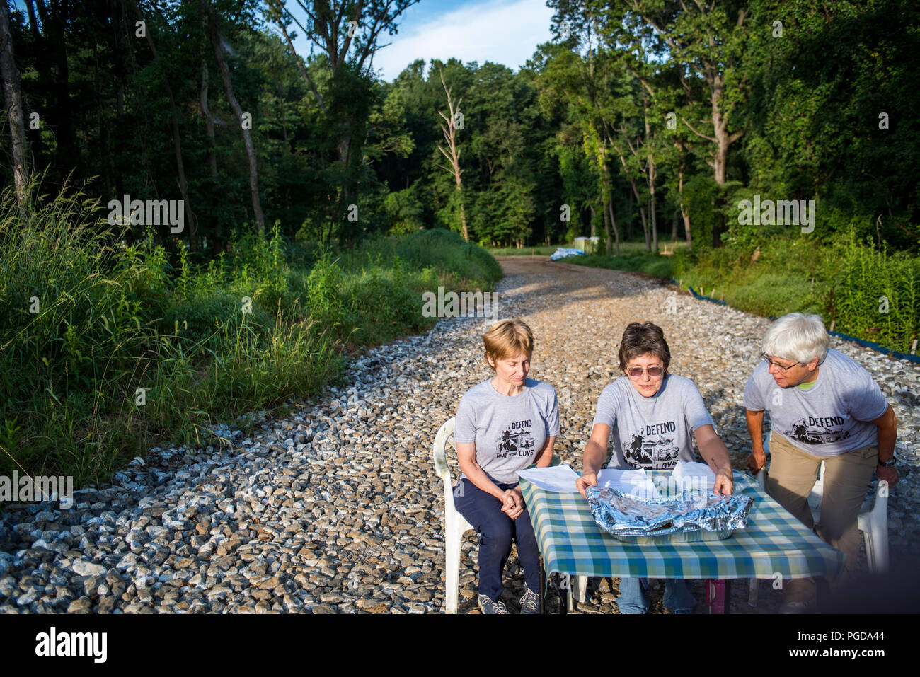 Pennsylvania, USA. 25 August 2018.  Ann Dixon, Abbie Wysor and Barbara Montabano set up a bake sale close to Sunoco's construction site. Residents held a bake sale at a pipeline construction site close to Glenwood Elemenary School in Middletown Township in protest of Sunoco's Mariner East Pipeline that threatens the safety of residents, students and daycare centers through a densley populated area. Three people were eventually arrested by state police for refusing to disperse following a lawful order. August 25 2018. Photo Credit: Chris Baker Evens. Credit: Christopher Evens/Alamy Stock Photo