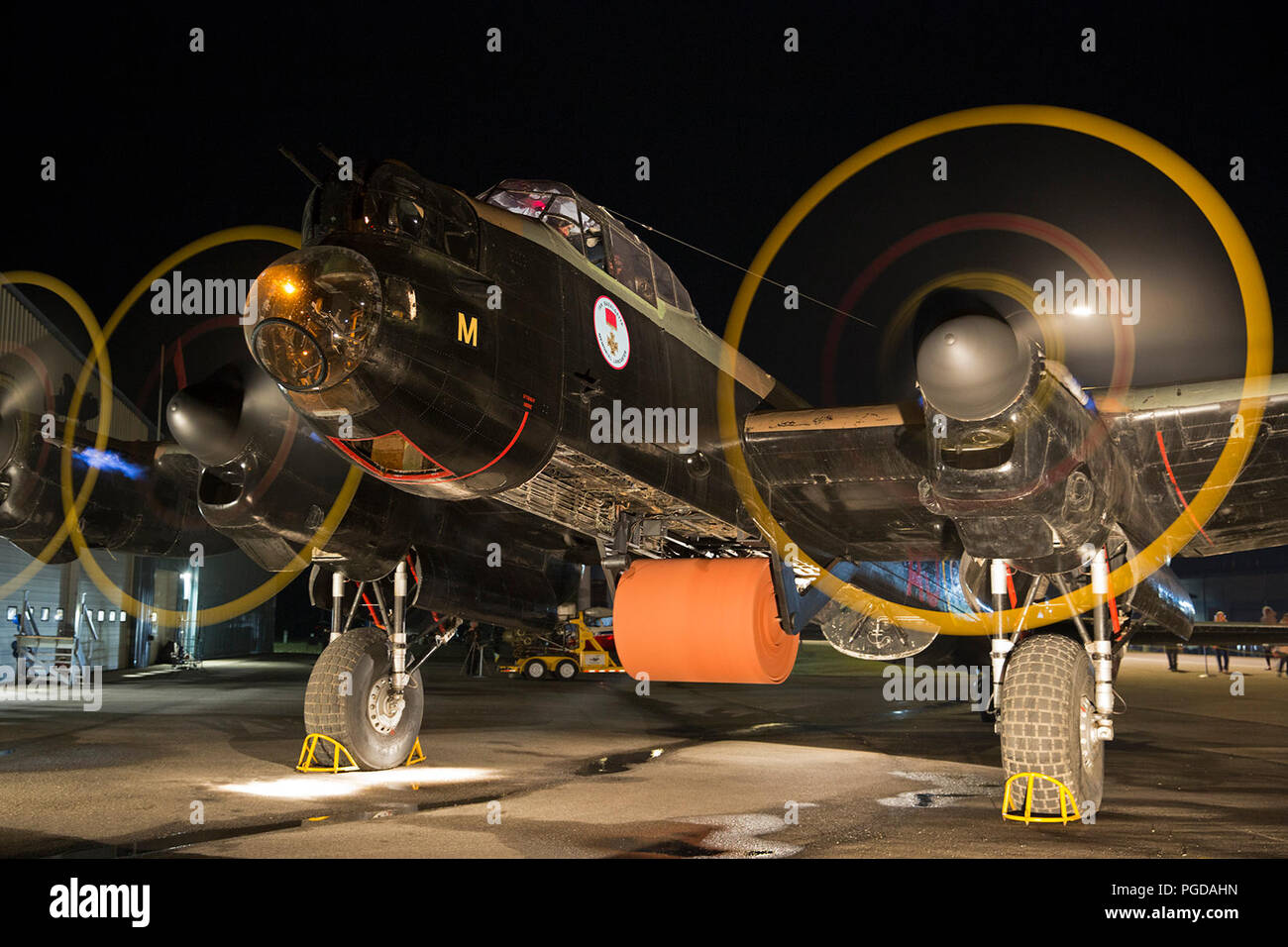 Nanton, Canada. 24th August, 2018.  Lancaster Bomber with a full-size, steel bouncing bomb spinning in the bomb-bay is started up during a night engine run at the Bomber Command Museum of Canada . The event is part of a 75th anniversary commemoration of the Dambusters Raid during World War II. Rosanne Tackaberry/Alamy Live News Stock Photo